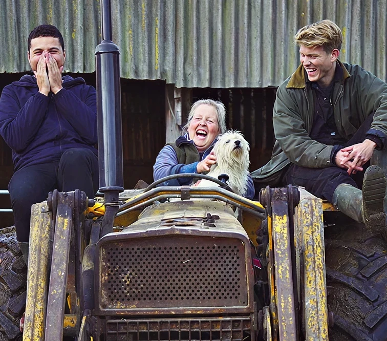 Two adults and a child sitting on a tractor