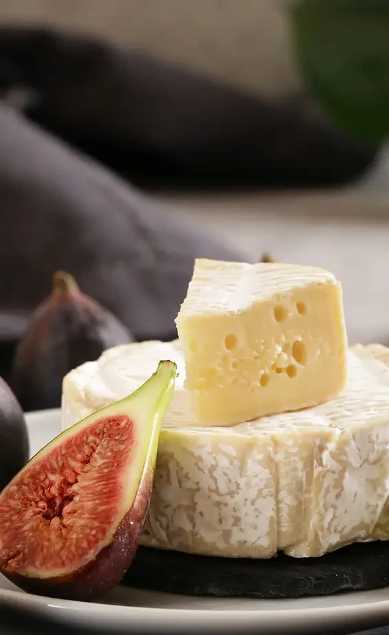 Soft and hard cheeses served with a sliced fig