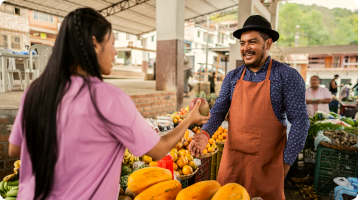 Customer talking to a farmer at a market stall