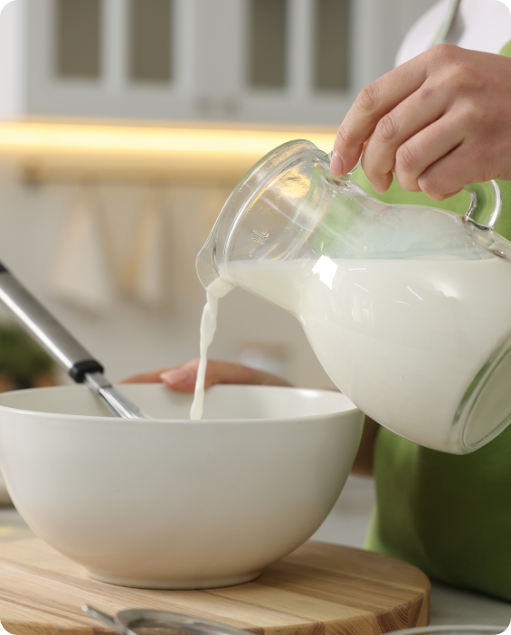 Person pouring milk into a bowl