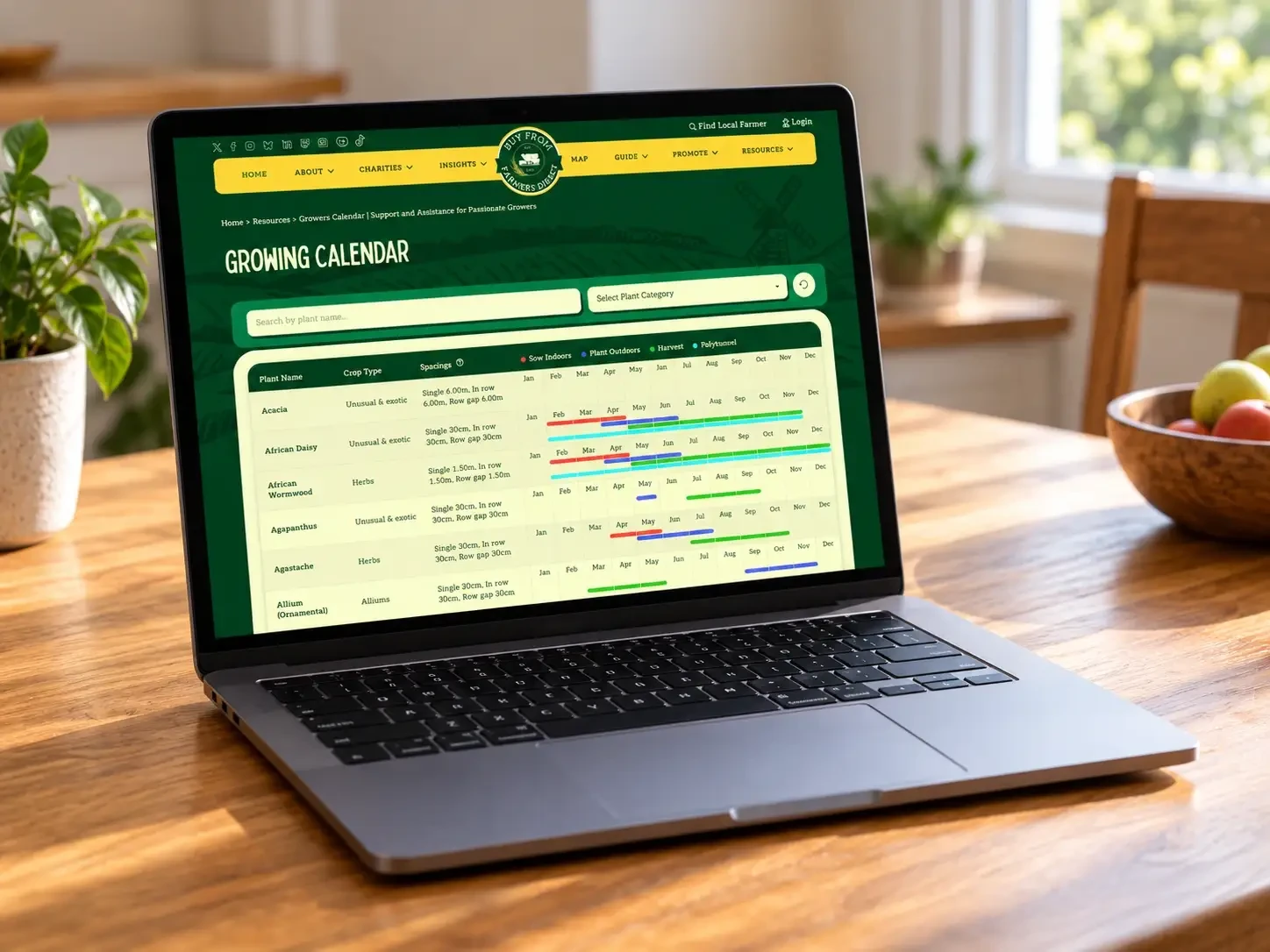 A laptop showing the BFFD growing calendar on a wooden table