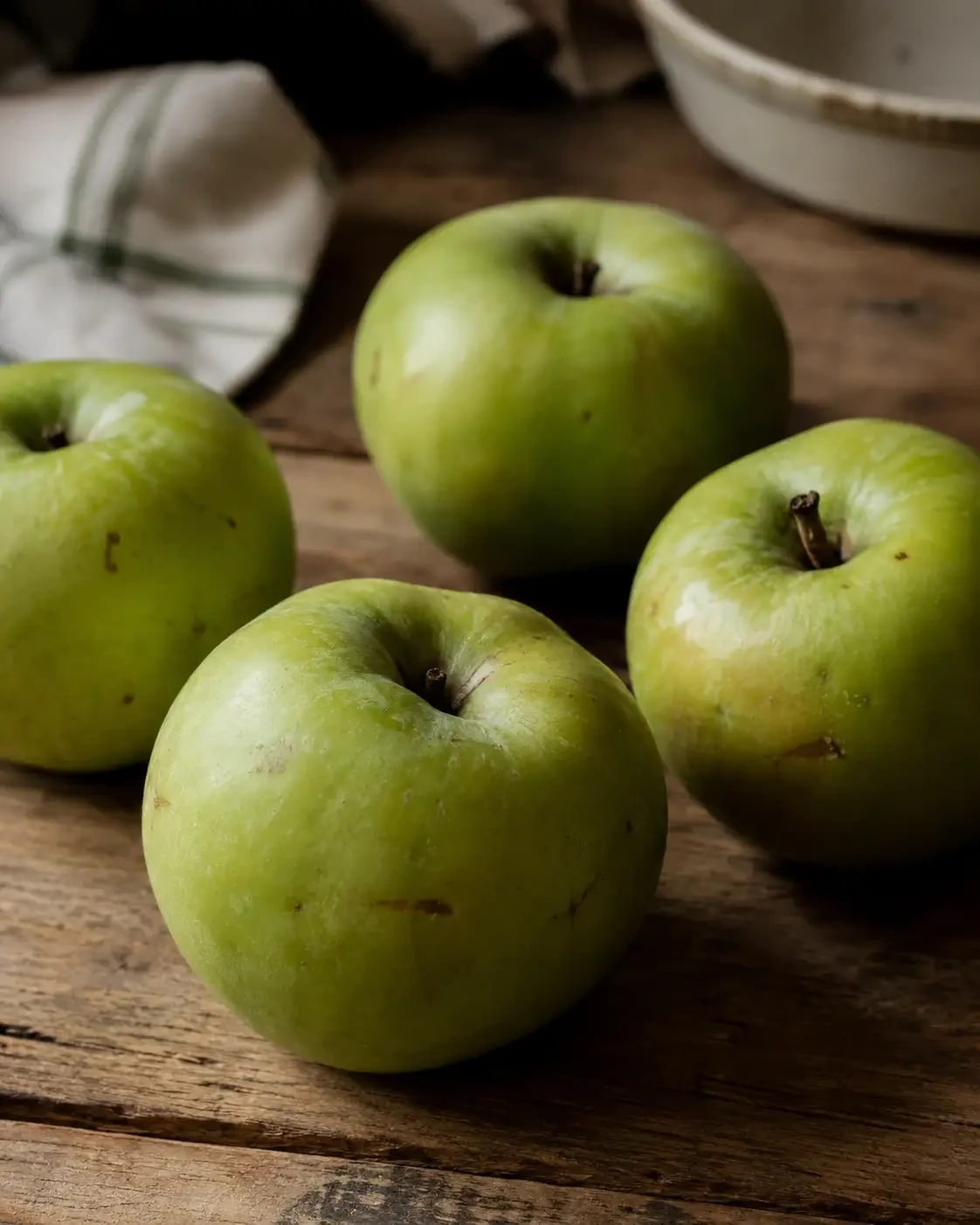 Green apples on a wooden table