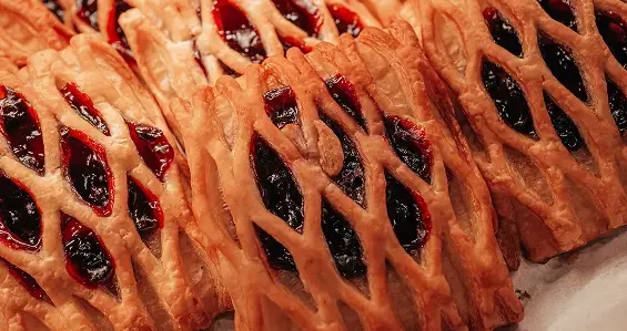 Golden lattice pastries filled with red jam