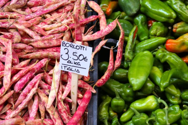 Borlotti beans beside peppers at a Bologna market