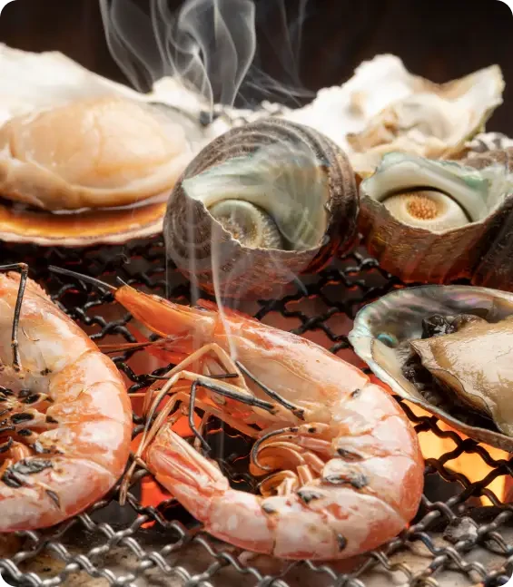 Prawns and shellfish cooking on a grill