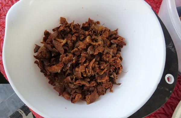 Opened bletted medlar fruits and brown flesh in a bowl