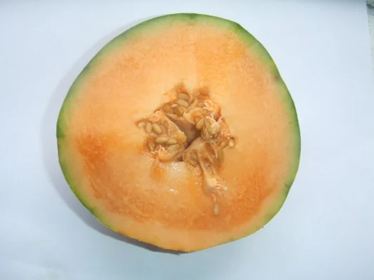 Cut Charentais melon showing orange flesh and seeds
