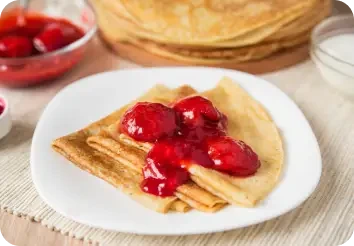Pancakes topped with red fruit jam