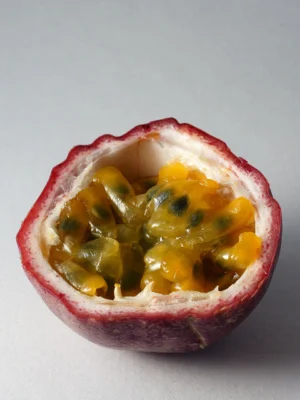 Opened purple passionfruit showing juicy orange yellow pulp and seeds
