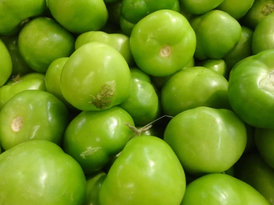 Green tomatillo fruits with their papery husks removed